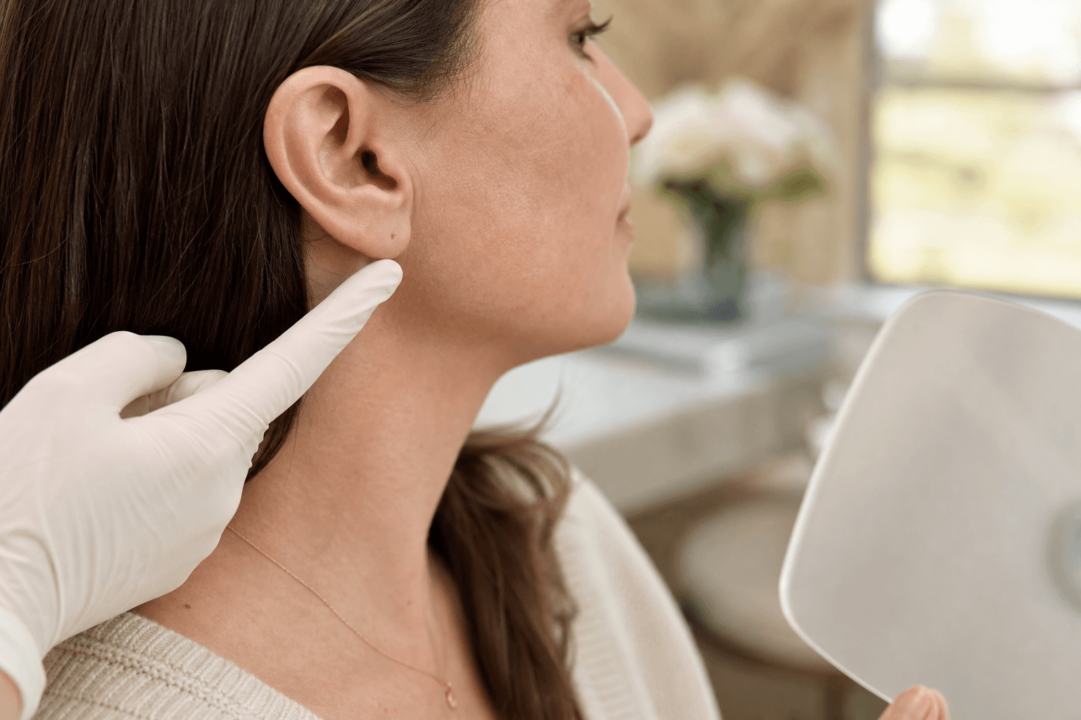 Adult ear re-piercing placement consultation with a med spa provider.